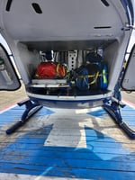 Open rear cabin of a medical helicopter on its landing pad