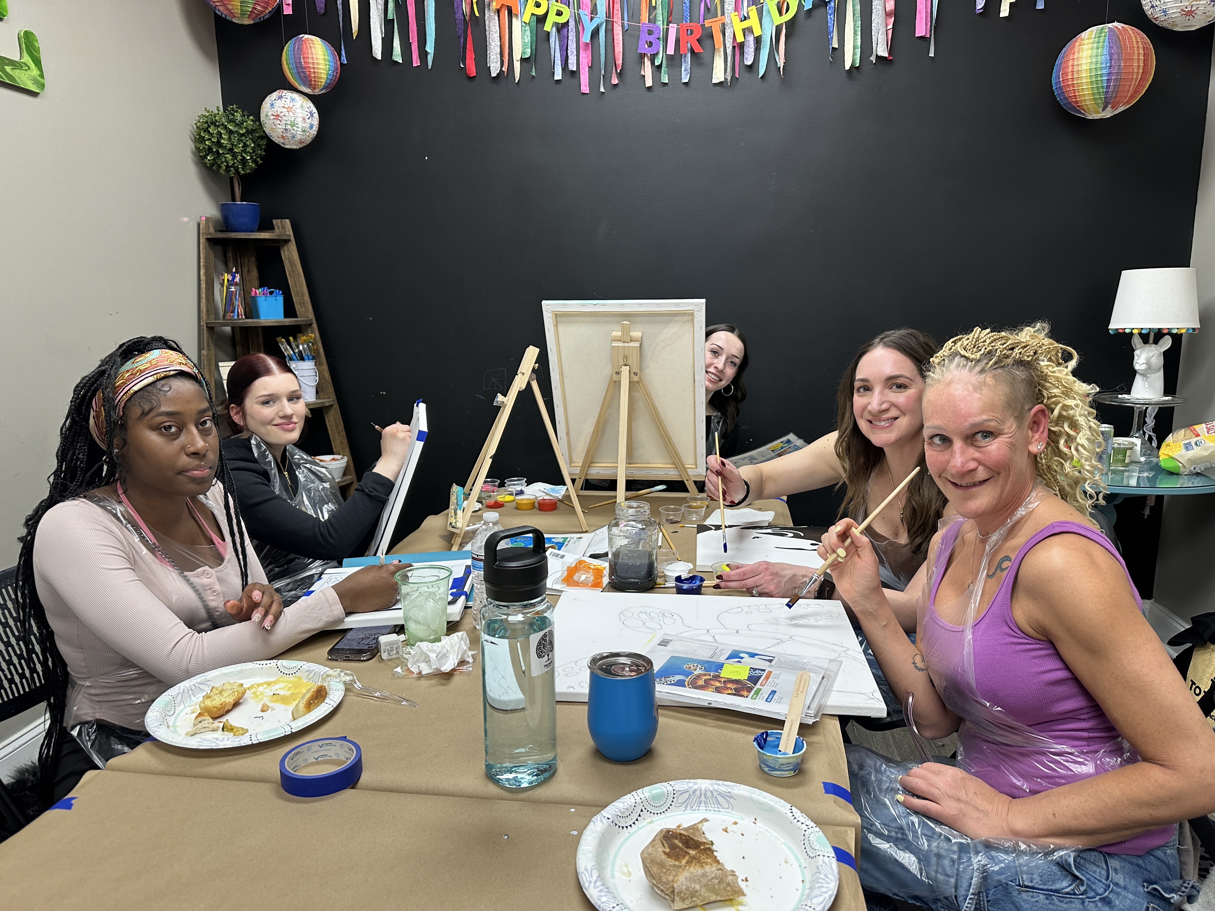 Guests painting together at a Triumph In Recovery craft night