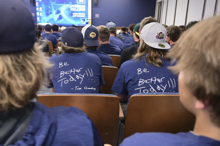 A room of supporters wearing Be Better Today shirts