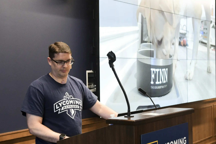 Tim Chiarolanza speaking at a podium