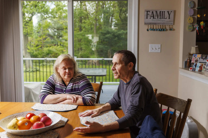 Tim Chiarolanza sitting at a kitchen table with a family member